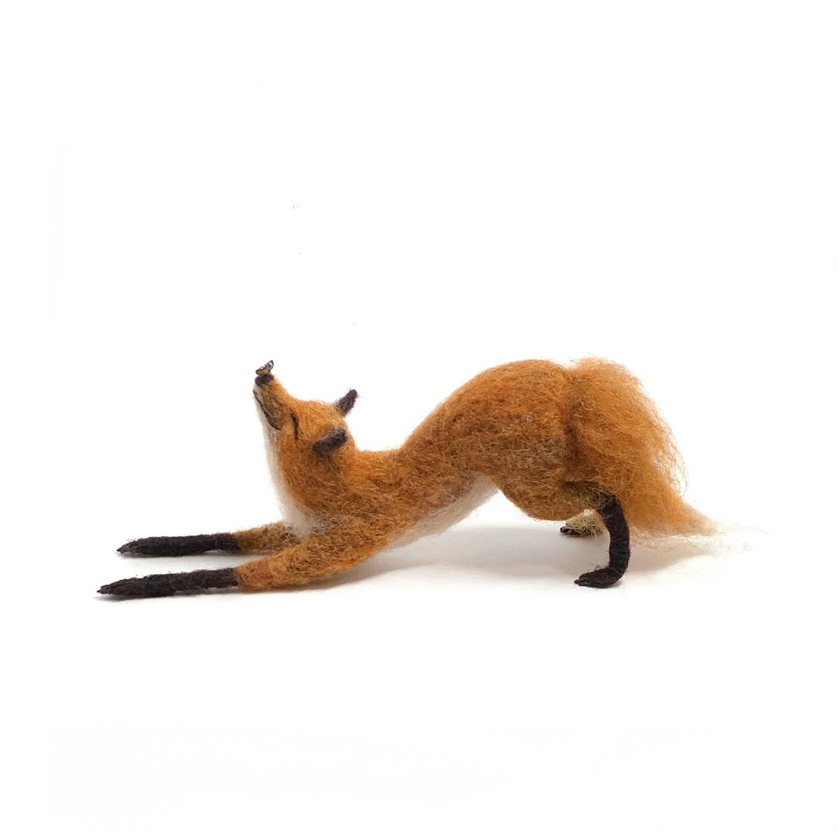 A hand-crafted needle-felted fox in orange and white wool