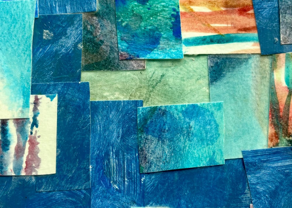 An abstract watercolor collage in blues and greens, made from torn painted paper on canvas